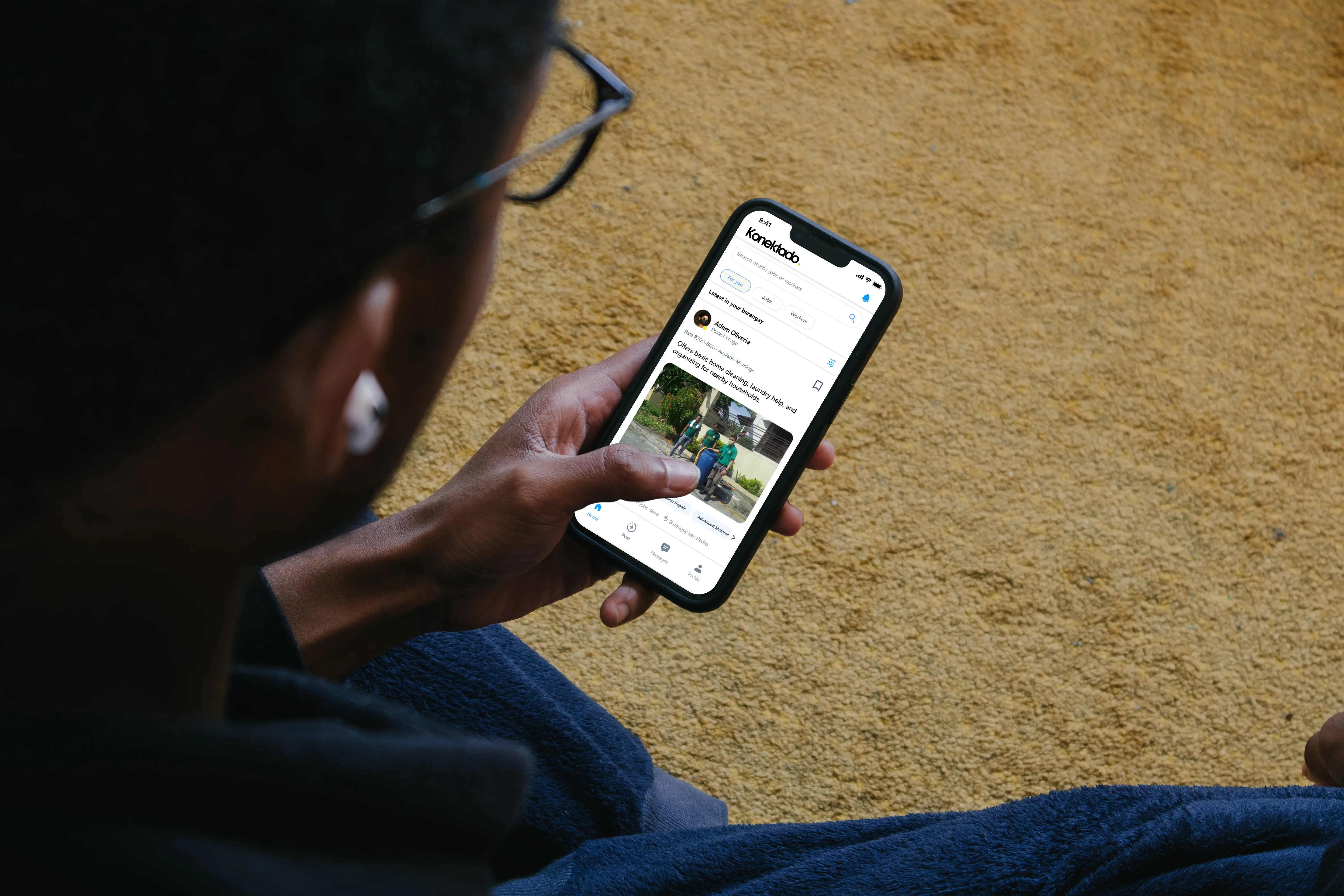 KONEKTADO nearby jobs feed shown on a phone held by a user